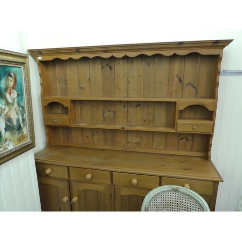 179 - A modern pine two-part dresser, the superstructure with staggered open shelves, over four frieze dra... 