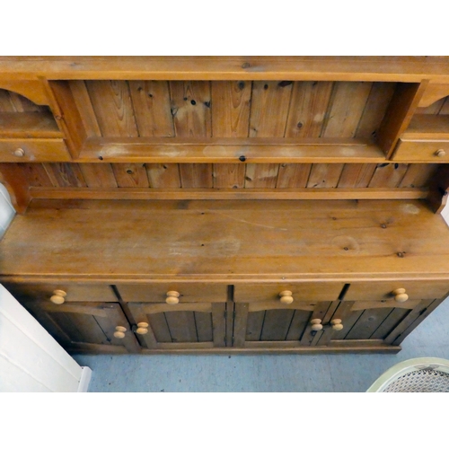 179 - A modern pine two-part dresser, the superstructure with staggered open shelves, over four frieze dra... 