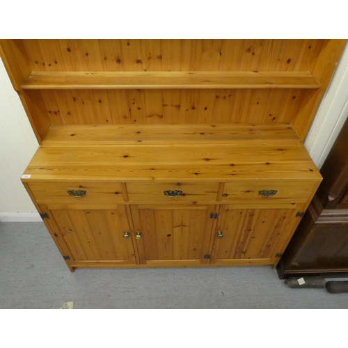 183 - A modern pine two-part dresser, the upper section with four open shelves, the back with three drawer... 