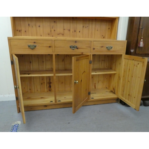 183 - A modern pine two-part dresser, the upper section with four open shelves, the back with three drawer... 