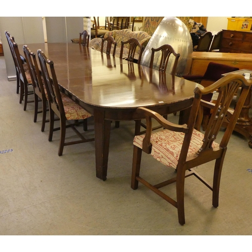 76 - A 1920s mahogany dining suite  comprising an extending table, raised on square, tapered legs  30