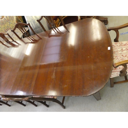 76 - A 1920s mahogany dining suite  comprising an extending table, raised on square, tapered legs  30