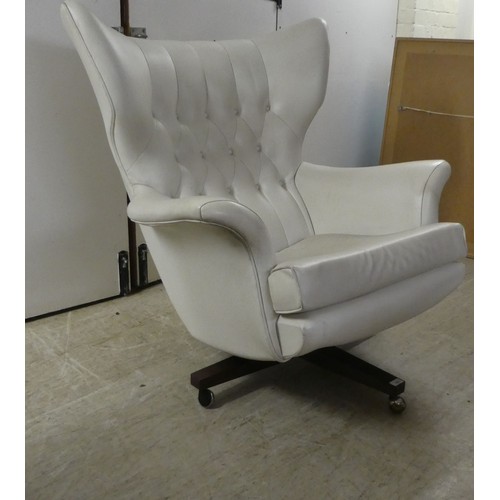 167 - A G-Plan 62 chair, on a swivel base and casters