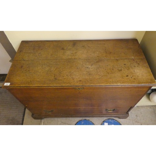 89 - A 19thC oak mule chest with straight sides and a hinged lid, over a front facing long base drawer, r... 