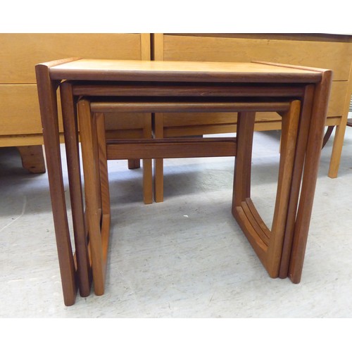 17 - 1980s teak furniture, viz. a nesting set of three tables  largest 19