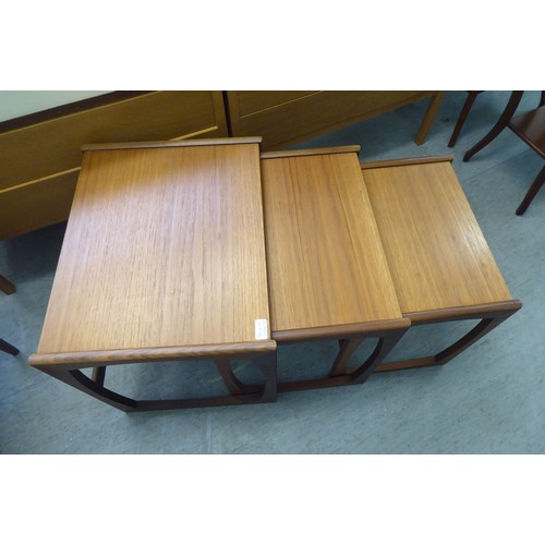 17 - 1980s teak furniture, viz. a nesting set of three tables  largest 19
