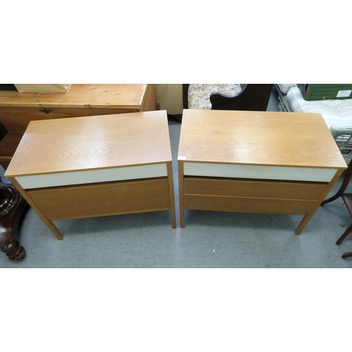 19 - A pair of G-Plan light oak and white painted, three drawer dressing chests, raised on square legs  2... 