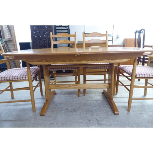 42 - An Ercol elm dining table, raised on planked supports  29