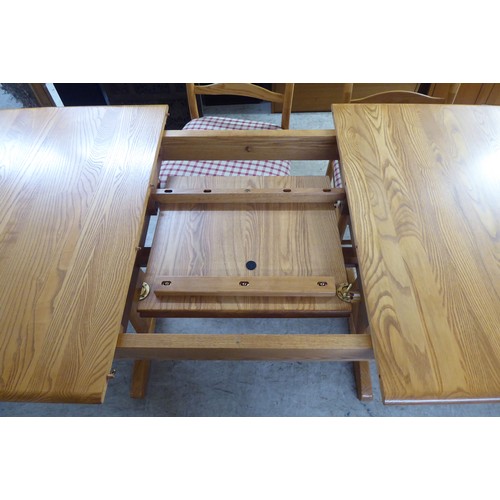 42 - An Ercol elm dining table, raised on planked supports  29