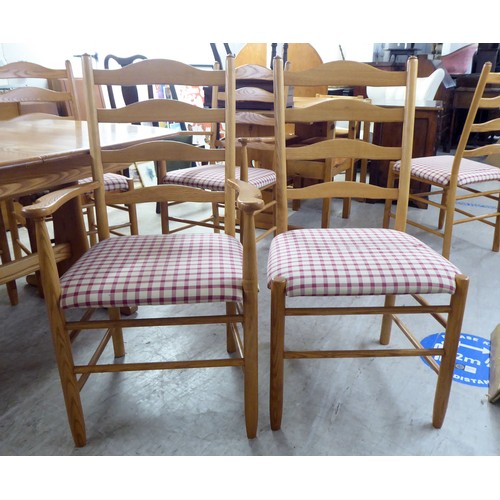 42 - An Ercol elm dining table, raised on planked supports  29