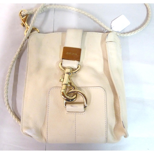 17 - Two cream coloured shoulder bags, one large with metal ornament; the other with a ropetwist handle