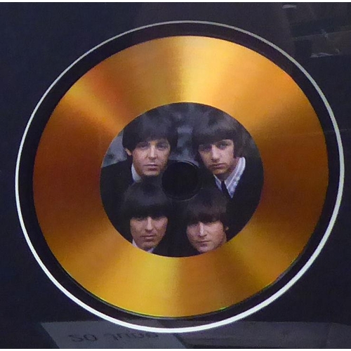 43 - A promotional photograph, featuring The Beatles and another in the centre of a gilded 45rpm disc, in... 