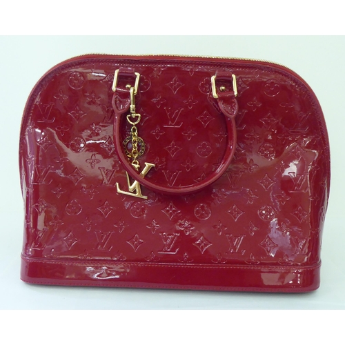 51 - A bright red patent, oversize handbag