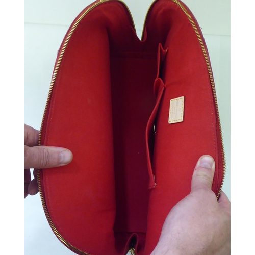 51 - A bright red patent, oversize handbag