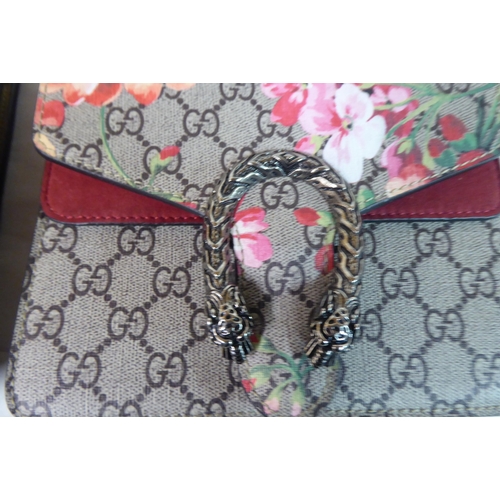 61 - Two similar shoulder bags, one with floral decoration, both with metal snake style catches