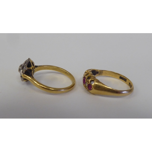 91 - Two 18ct rings, one set with a diamond cluster; the other set with alternating rubies and diamonds