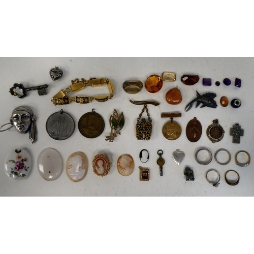 97 - A mixed lot: to include a white metal, mask design brooch