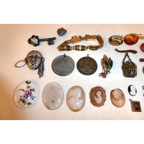 97 - A mixed lot: to include a white metal, mask design brooch