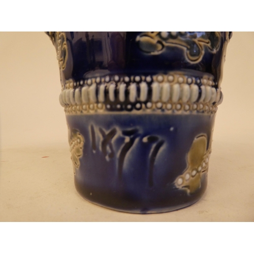 100 - A late Victorian Doulton Lambeth stoneware beaker, decorated with applied and moulded floral ornamen... 