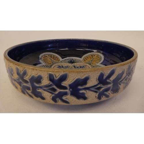 105 - A late Victorian Doulton Lambeth stoneware shallow bowl, decorated with moulded and applied floral a... 