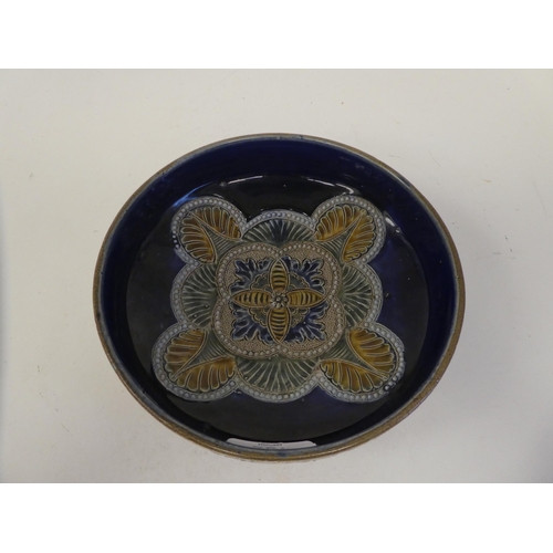 105 - A late Victorian Doulton Lambeth stoneware shallow bowl, decorated with moulded and applied floral a... 