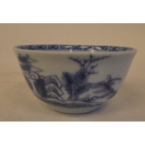 109 - A Nanking Cargo porcelain tea bowl and saucer, decorated in blue and white with buildings  bear... 