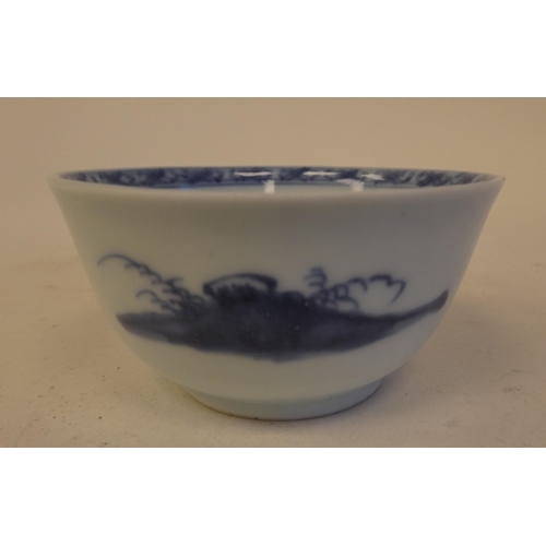 109 - A Nanking Cargo porcelain tea bowl and saucer, decorated in blue and white with buildings  bear... 