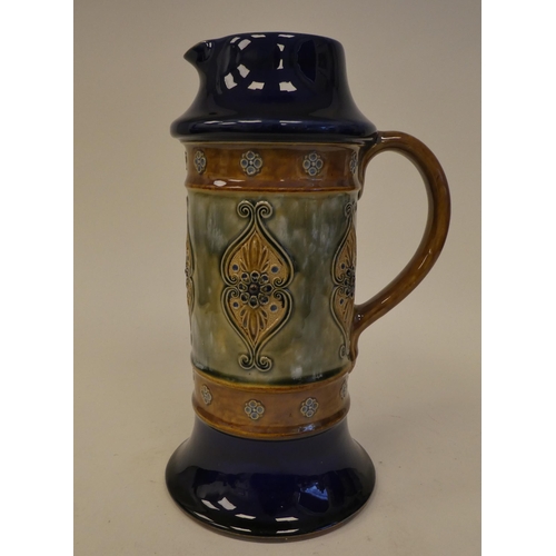 118 - A Royal Doulton blue, green and brown glazed stoneware water jug of cylindrical form, on a splayed b... 