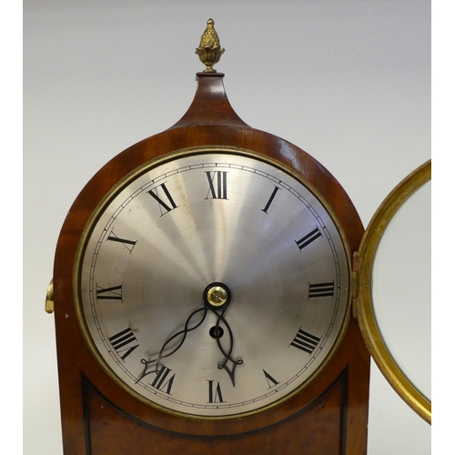 12 - A 19thC round arched mahogany veneered bracket timepiece with a pineapple finial and cast brass flan... 