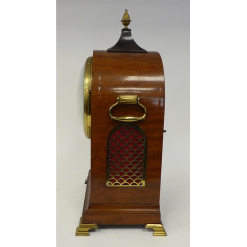 12 - A 19thC round arched mahogany veneered bracket timepiece with a pineapple finial and cast brass flan... 