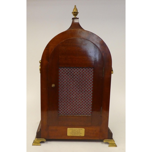 12 - A 19thC round arched mahogany veneered bracket timepiece with a pineapple finial and cast brass flan... 