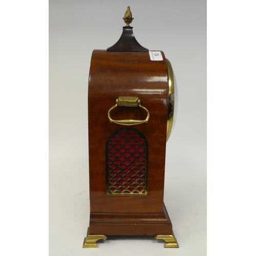 12 - A 19thC round arched mahogany veneered bracket timepiece with a pineapple finial and cast brass flan... 