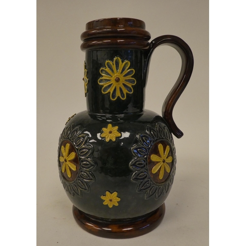 120 - A Doulton Lambeth brown, green and sand coloured stoneware flask of bulbous form with a narrow, stra... 