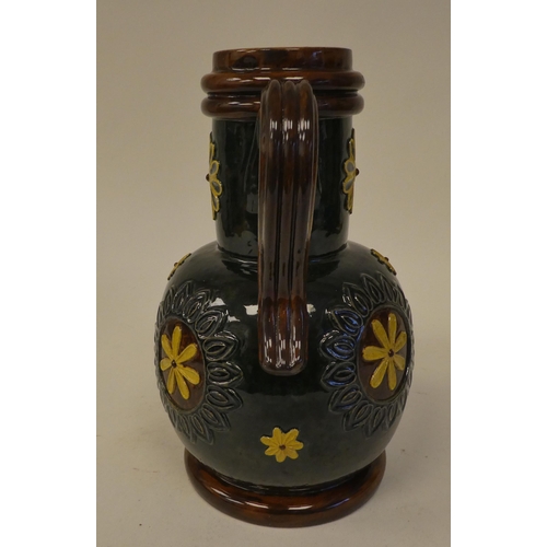 120 - A Doulton Lambeth brown, green and sand coloured stoneware flask of bulbous form with a narrow, stra... 