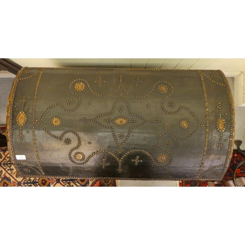 122 - An antique Continental, domed top trunk with decoratively stud finished and hide covered ornament, s... 