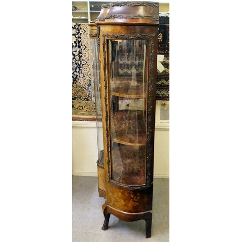 13 - A 19thC kingwood veneered, serpentine front vitrine with scrolled metal mounts, the platform cornice... 