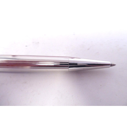 15 - A Cartier bi-coloured stainless steel ballpoint pen  boxed