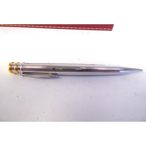 15 - A Cartier bi-coloured stainless steel ballpoint pen  boxed