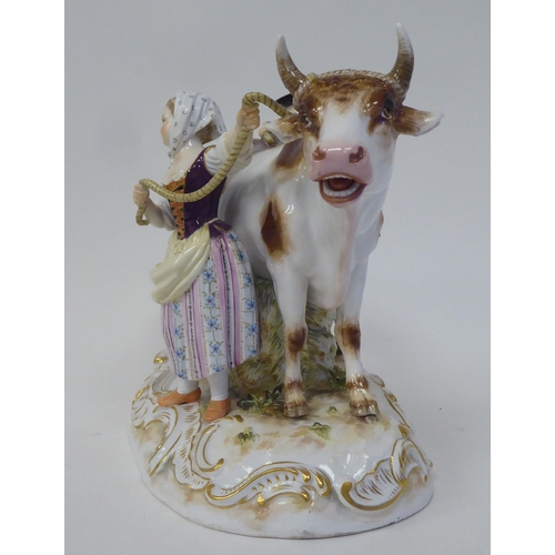 21 - A Meissen porcelain group, featuring a cow, a milkmaid and her suitor  inscribed R78, on an ova... 