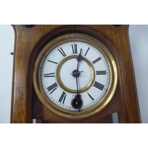 22 - An early 20thC Gothic inspired, ebonised and glazed, fruitwood cased Vienna design wall timepiece wi... 