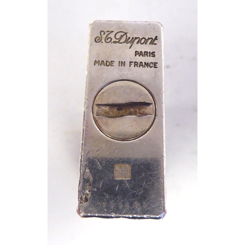 27 - An ST Dupont white metal cased, gas filled cigarette lighter  boxed with a sleeve