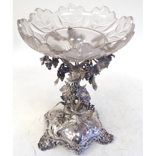 301 - A late Victorian/Edwardian silver plated table centrepiece, the ornately cast stand with fruiting vi... 