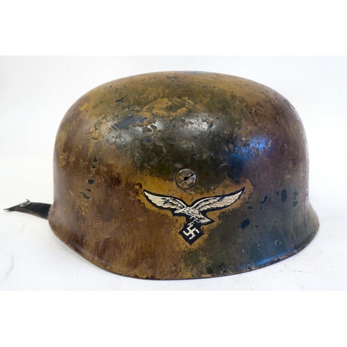 303 - A German Fallschimjaq parachutist's Normandy camouflage helmet with a hide liner and four point chin... 