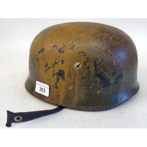 303 - A German Fallschimjaq parachutist's Normandy camouflage helmet with a hide liner and four point chin... 