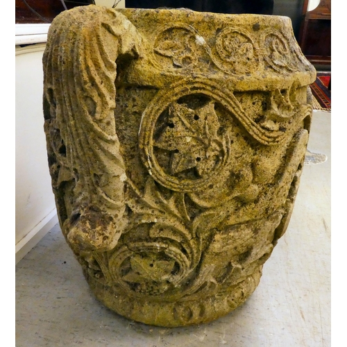 311 - An antique stone, twin handled urn, carved in relief with mythical birds, foliage and other ornament... 