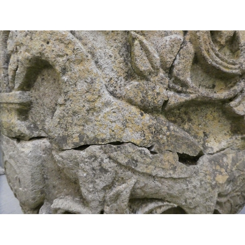 311 - An antique stone, twin handled urn, carved in relief with mythical birds, foliage and other ornament... 