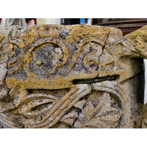 311 - An antique stone, twin handled urn, carved in relief with mythical birds, foliage and other ornament... 