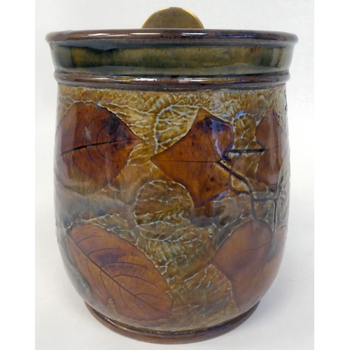 318 - A Royal Doulton stoneware tobacco jar, decorated in colours with autumnal leaves, the lid secured by... 