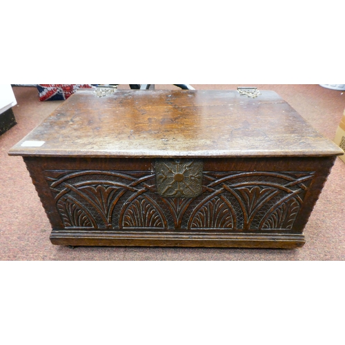 327 - An 18thC planked oak bible box with a lunette carved front panel, the lid on later cast and rivetted... 