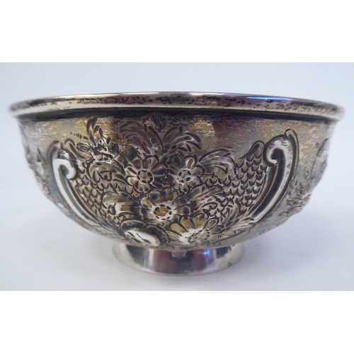 331 - A 19thC Irish silver footed bowl, embossed and chased with scrolls, vignettes and flora  bears ... 